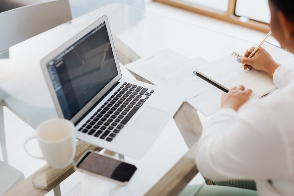 How to work hard — Person Working Hard At Desk With Laptop And Notebook - image 2