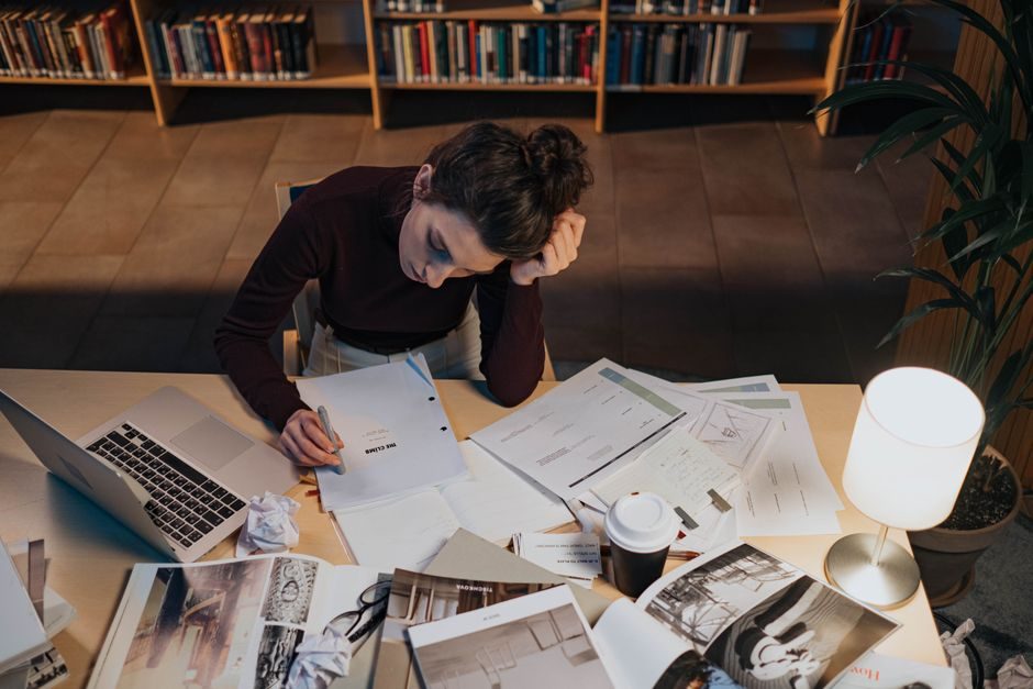 How to work hard — Person Working Hard At Desk With Laptop And Books - image 2